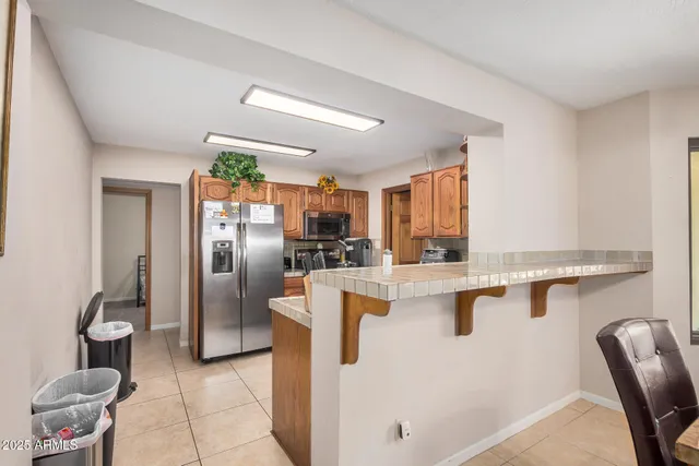 a kitchen with stainless steel appliances granite countertop a refrigerator and a stove