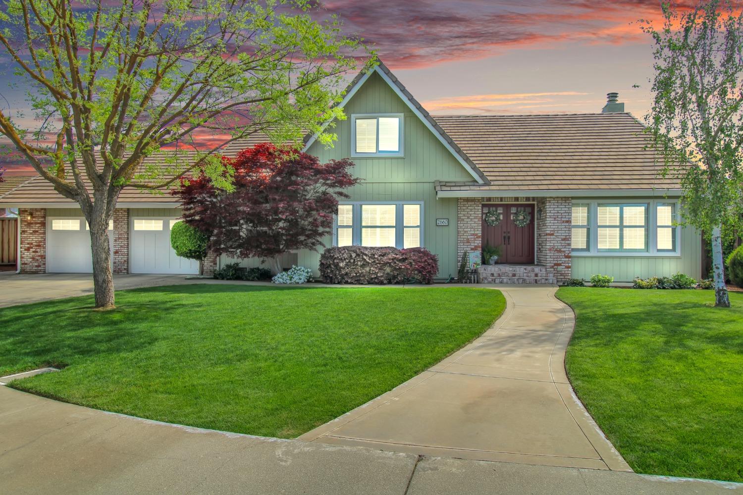 2660 Emerald Way Turlock, CA 95382 - Photo 1 of 1 a front view of a house with a yard and trees