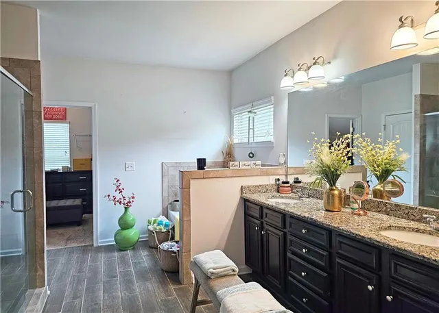 a bathroom with a sink double vanity granite and a mirror
