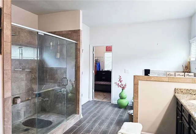 a bathroom with a sink mirror and shower