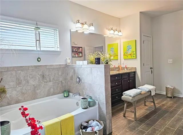 a bathroom with a tub sink and a mirror