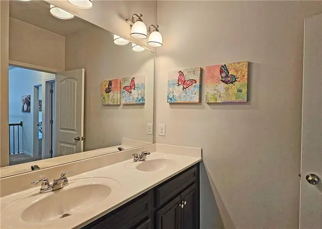a bathroom with a double vanity sink and a mirror