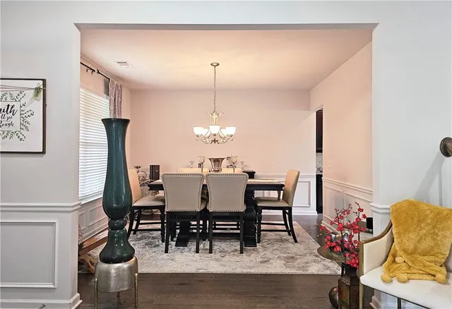 a view of a dining room with furniture and chandelier