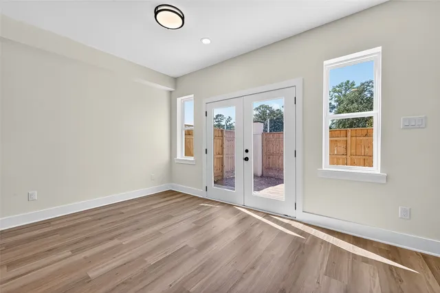 a large kitchen with stainless steel appliances a large counter top a sink a refrigerator and a microwave