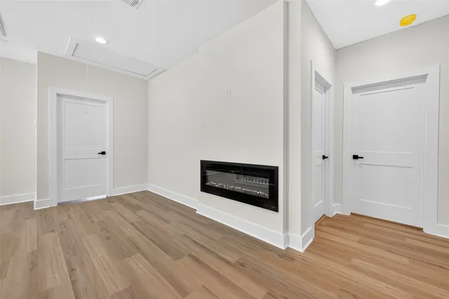 an empty room with a window and a ceiling fan