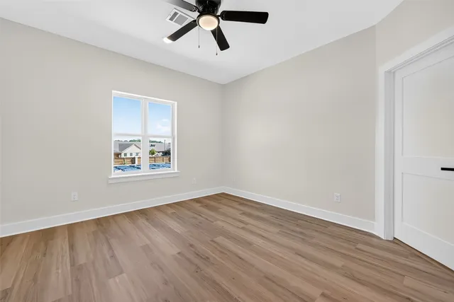 a view of room with hardwood floor and window