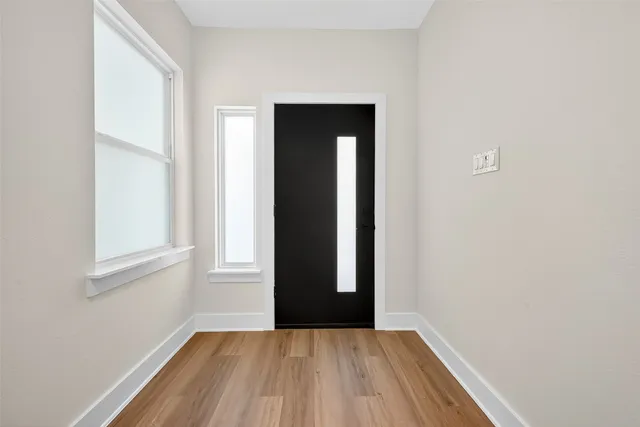 a large kitchen with stainless steel appliances granite countertop a stove a sink dishwasher and a oven with wooden floor