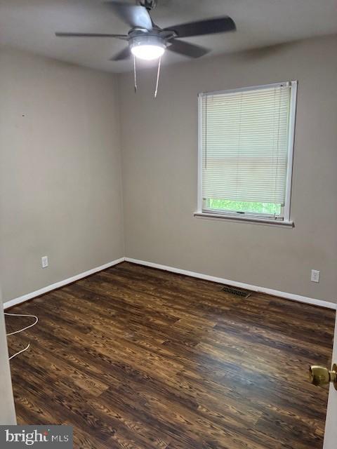 206 Calvert Drive Lusby, MD 20657 - Photo 21 of 32 an empty room with wooden floor chandelier fan and windows
