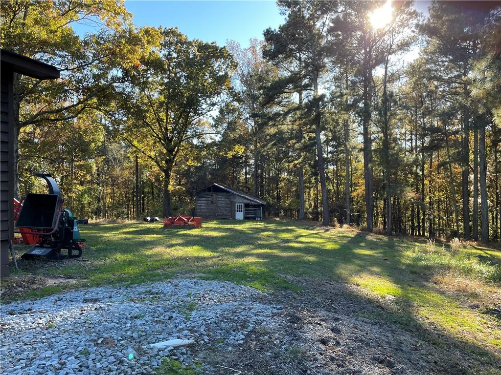 1585 Jimmy Dodd Road Buford, GA 30518 - Photo 15 of 30 a backyard of a house with barbeque oven table and chairs