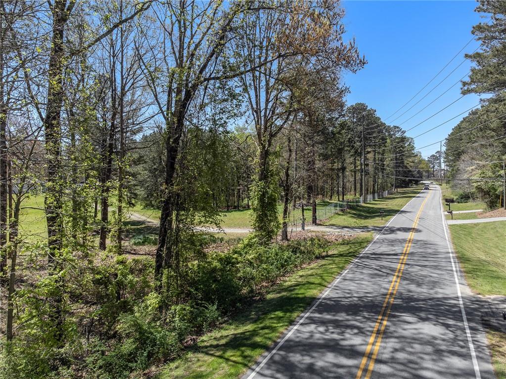 1585 Jimmy Dodd Road Buford, GA 30518 - Photo 4 of 30 a walkway with trees on sides