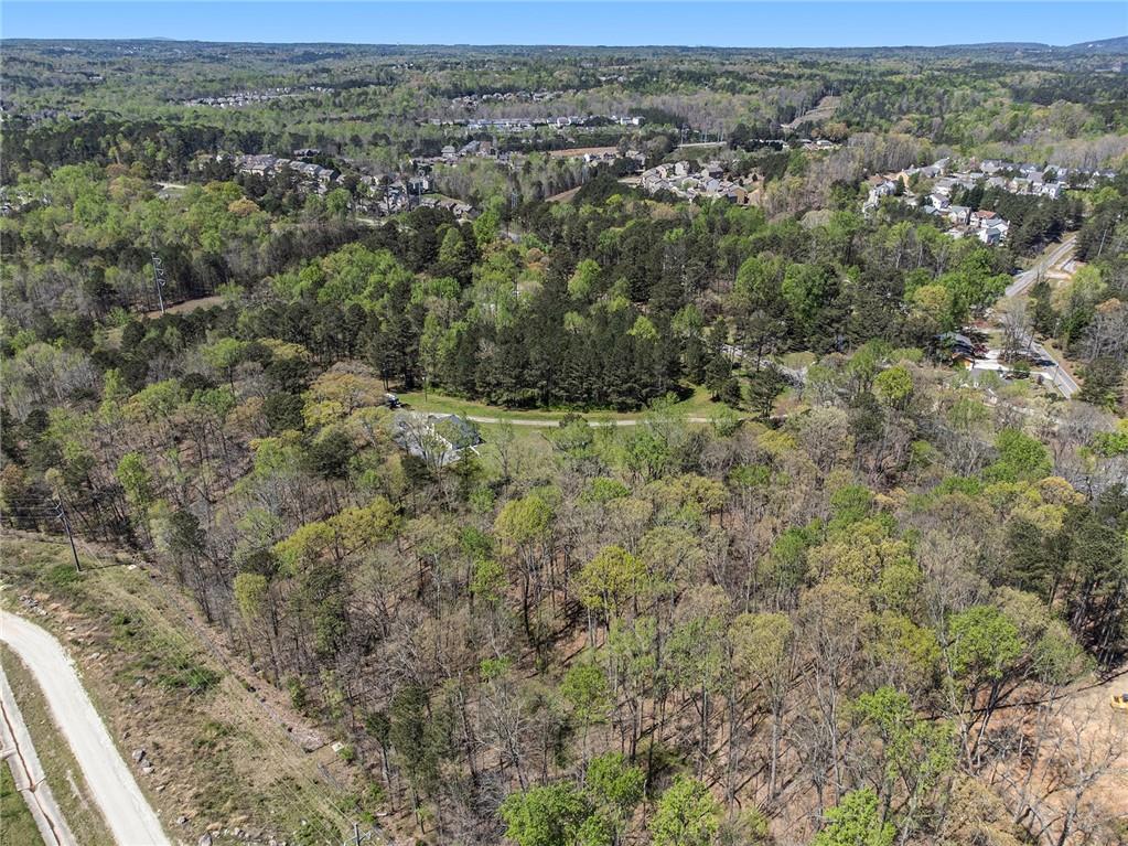 1585 Jimmy Dodd Road Buford, GA 30518 - Photo 9 of 30 an aerial view of residential houses with outdoor space and trees