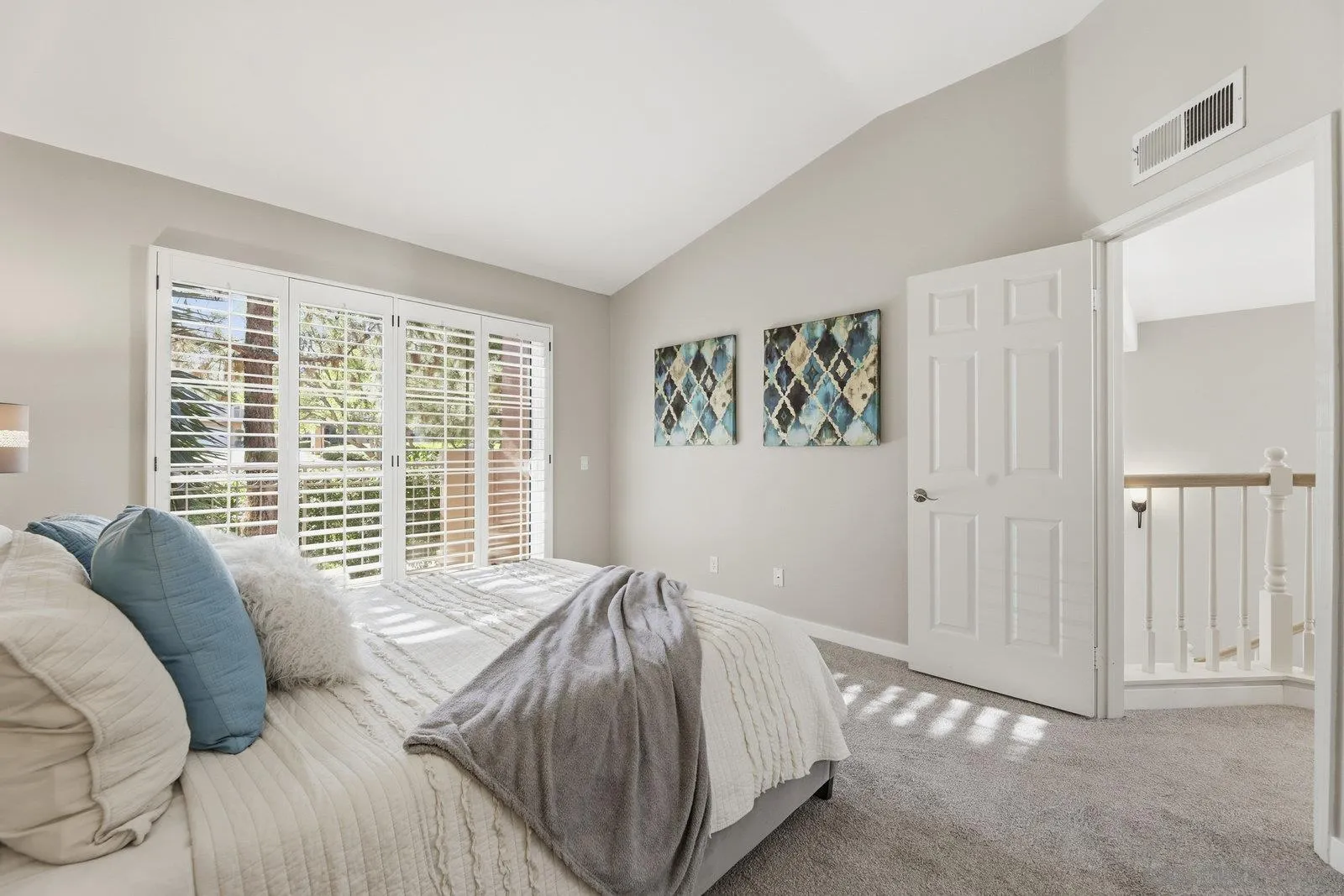 11908 Tivoli Park Row, Unit 7 San Diego, CA 92128 - Photo 19 of 34 a bed sitting in a bedroom next to a window