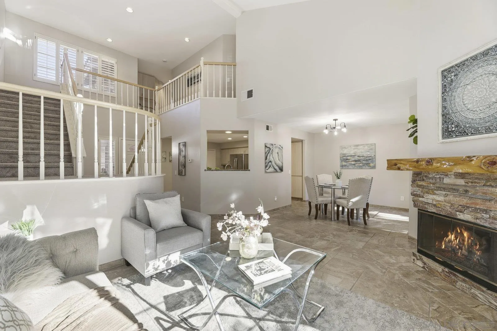 11908 Tivoli Park Row, Unit 7 San Diego, CA 92128 - Photo 2 of 34 a living room with furniture a fireplace and a table with wooden floor