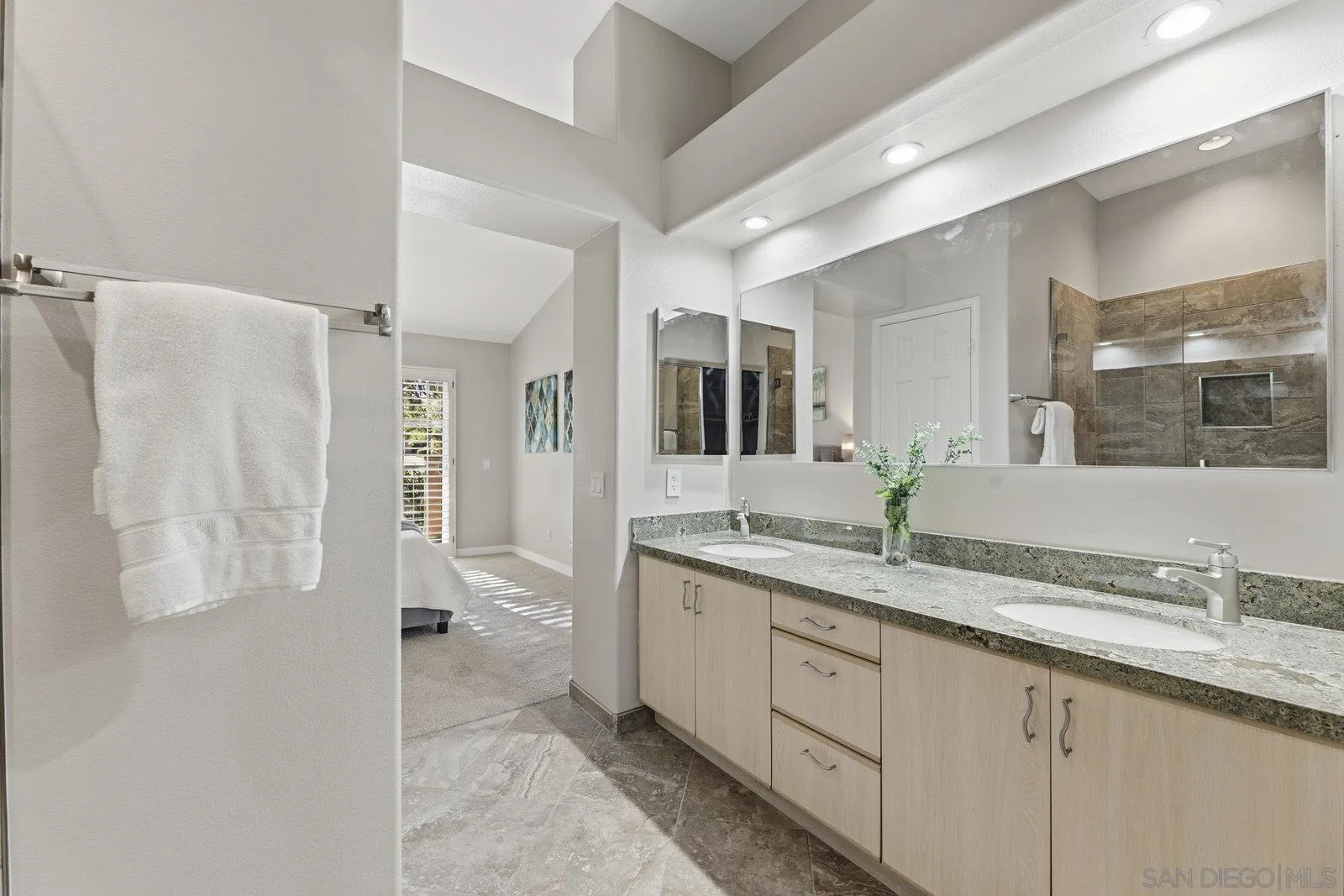 11908 Tivoli Park Row, Unit 7 San Diego, CA 92128 - Photo 21 of 34 a spacious bathroom with a granite countertop sink mirror and double