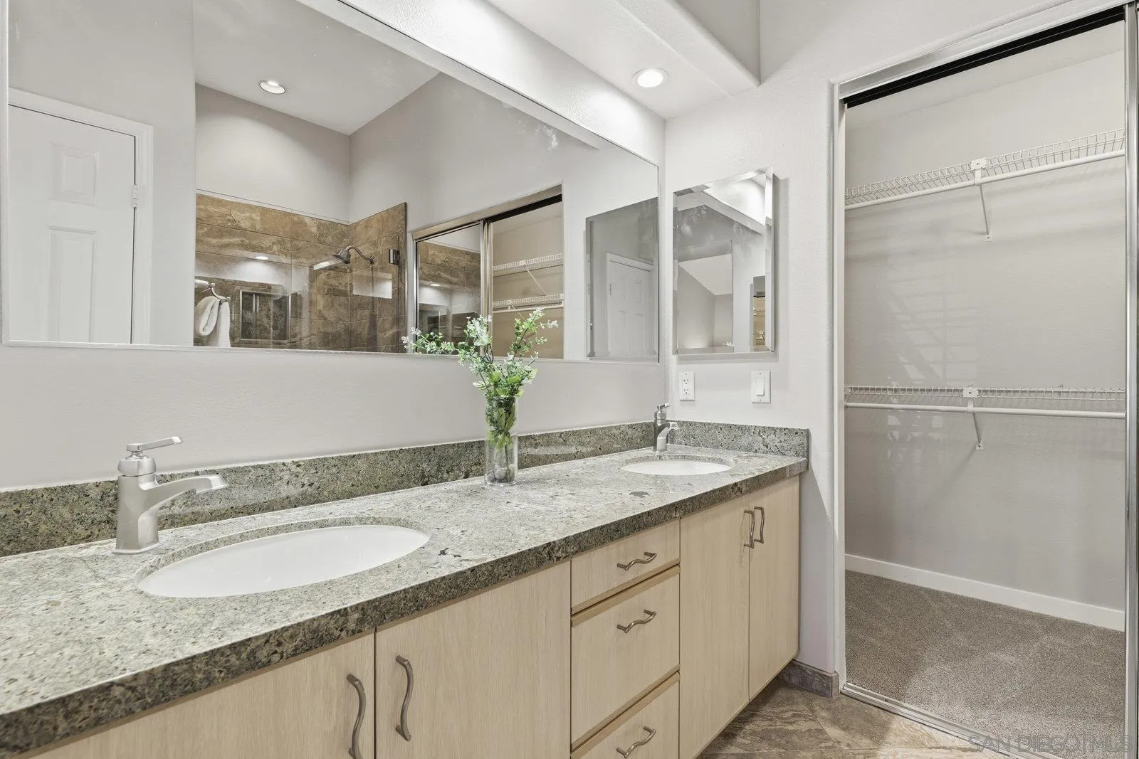 11908 Tivoli Park Row, Unit 7 San Diego, CA 92128 - Photo 22 of 34 a bathroom with a granite countertop sink mirror and double