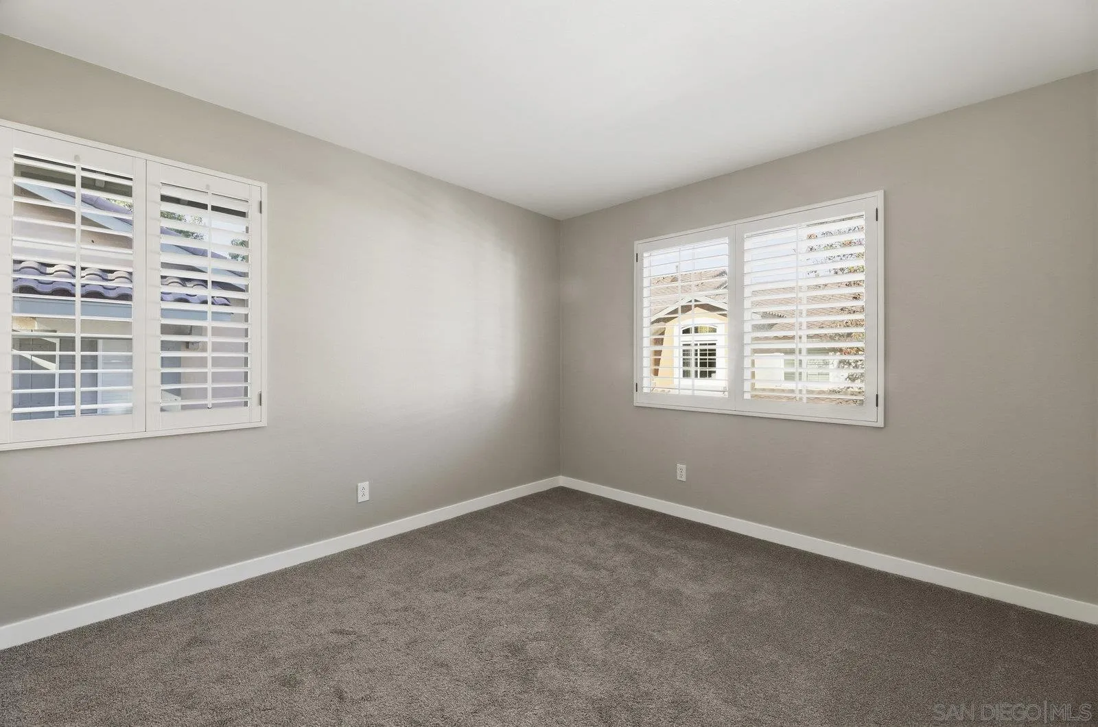 11908 Tivoli Park Row, Unit 7 San Diego, CA 92128 - Photo 24 of 34 a view of an empty room with a window