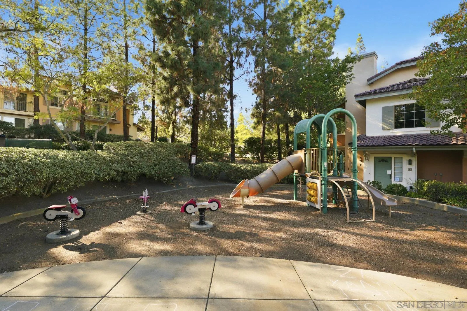 11908 Tivoli Park Row, Unit 7 San Diego, CA 92128 - Photo 32 of 34 a view of a park with swings and slides