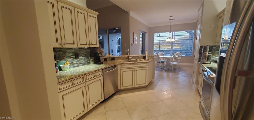 7855 Founders Circle Naples, FL 34104 - Photo 9 of 15 Left Side of Kitchen with view of Lake and Pool