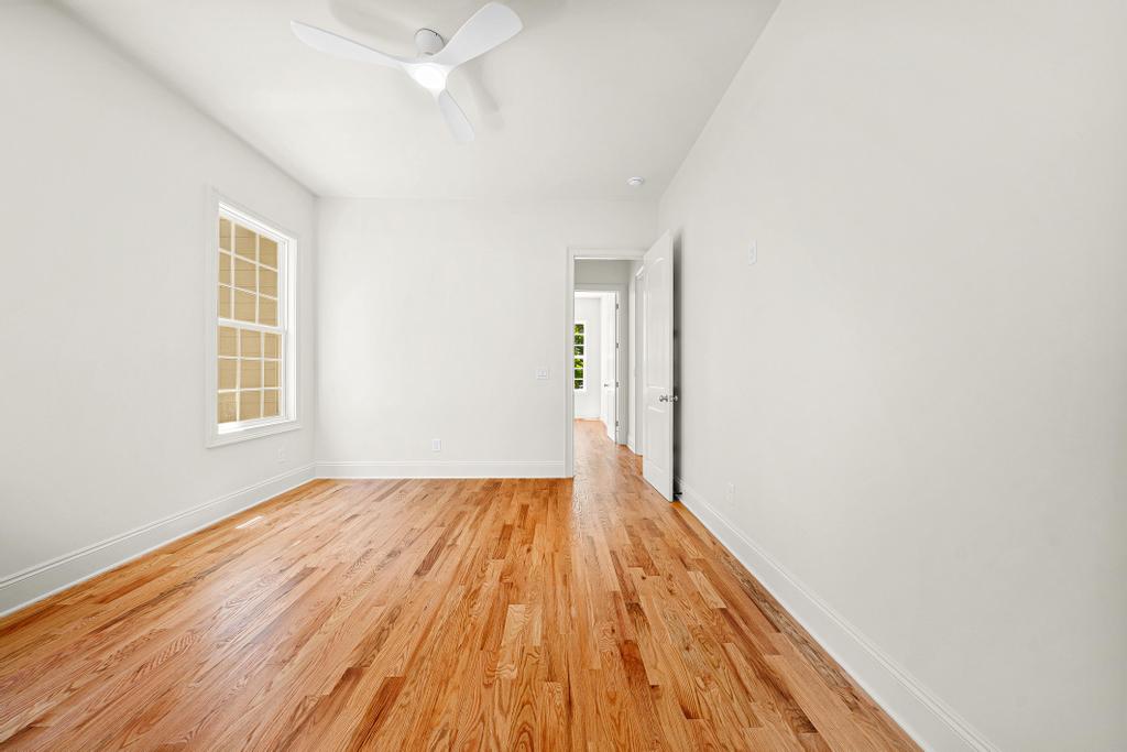 707 Vickery Street Extension Hartwell, GA 30643 - Photo 29 of 50 Hardwood floors and a sleek ceiling fan define this inviting, bright bedroom.