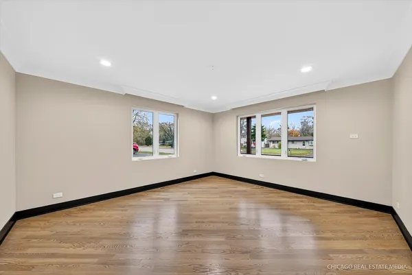a view of kitchen view wooden floor appliances and cabinets