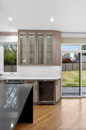 a bathroom with a granite countertop shower and a window