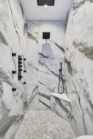 a bathroom with a double vanity sink mirror and toilet