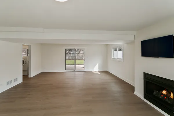 a view of an empty room with a flat screen tv and a fireplace