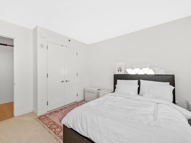 a bedroom with a bed and a night stand