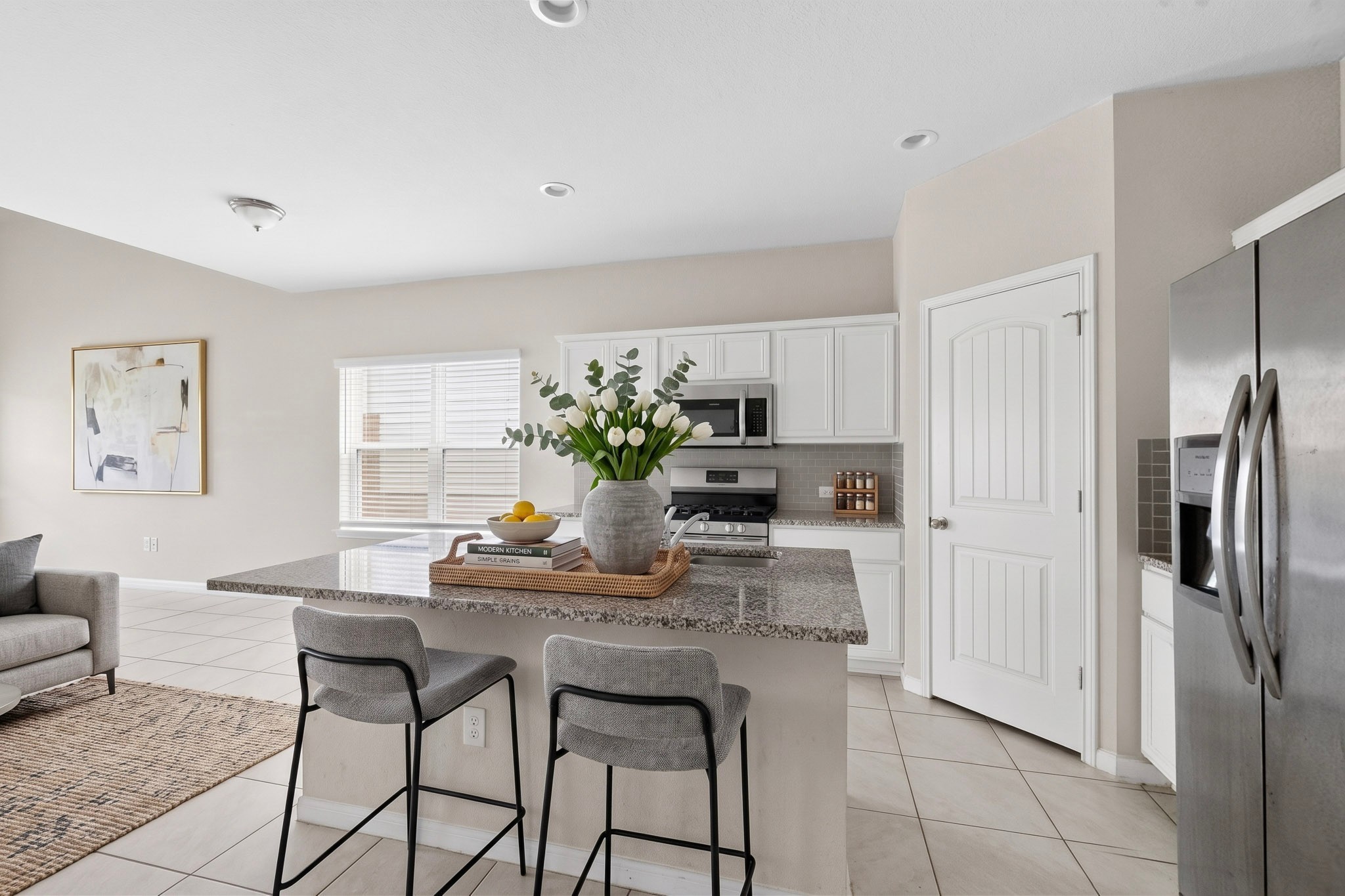 6920 Ranchito Drive Austin, TX 78744 - Photo 1 of 4 A well-appointed kitchen features a spacious island with a granite countertop, offering both utility and a casual dining spot.