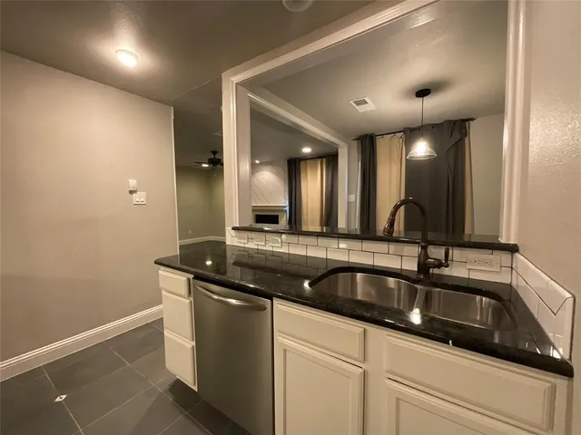 a kitchen with stainless steel appliances granite countertop a sink and cabinets