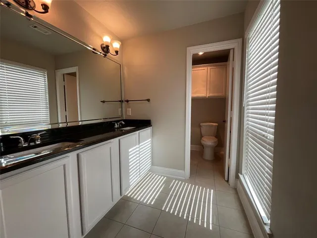 a bathroom with a sink a light fixture and a toilet