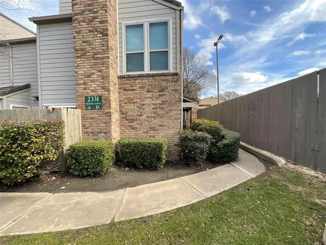 a view of a brick house with a large window