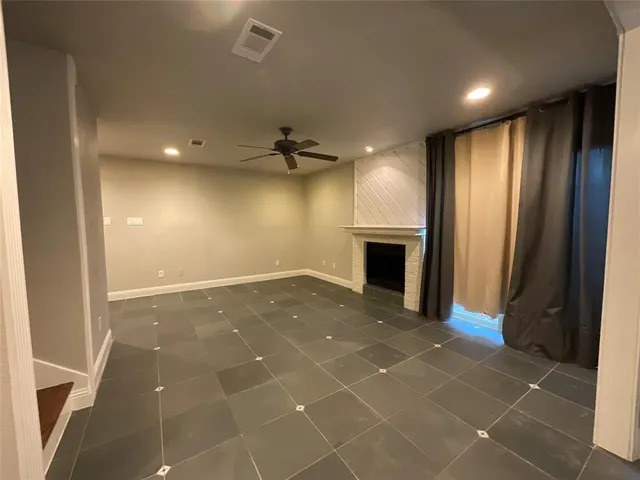 a view of an empty room with a fireplace