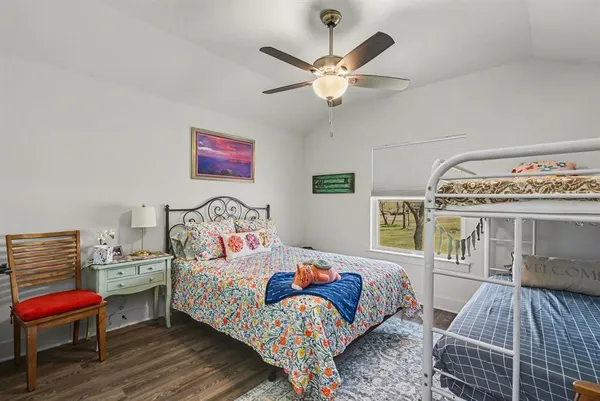 a bathroom with a granite countertop sink mirror vanity and toilet