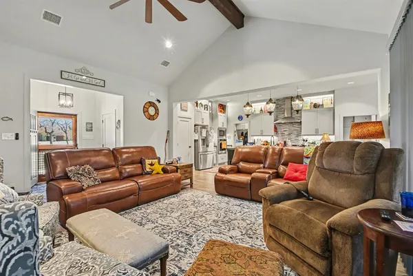 a living room with furniture ceiling fan and a rug