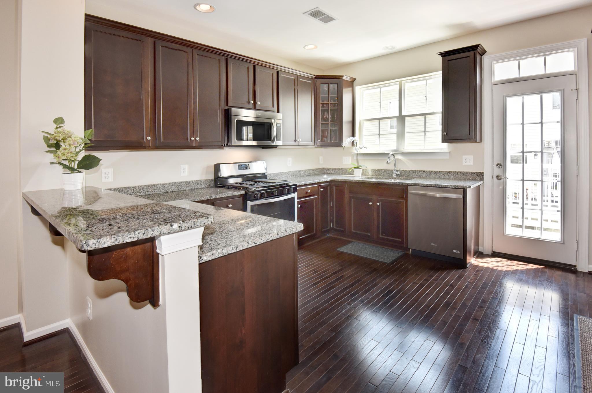 7477 Riding Meadow Way Manassas, VA 20111 - Photo 10 of 28 Dark hardwood flooring throughout this level