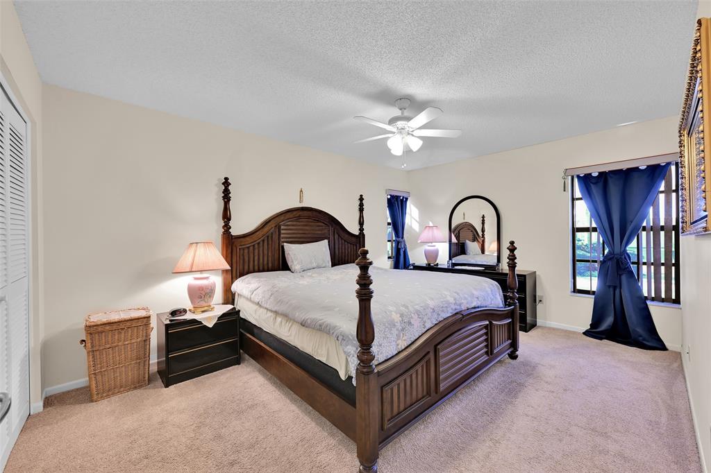 7312 Northwest 83rd Way Tamarac, FL 33321 - Photo 14 of 21 a bedroom with a bed and a chandelier