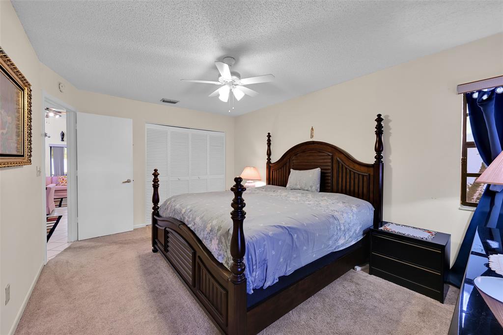 7312 Northwest 83rd Way Tamarac, FL 33321 - Photo 15 of 21 a bedroom with a bed and a closet