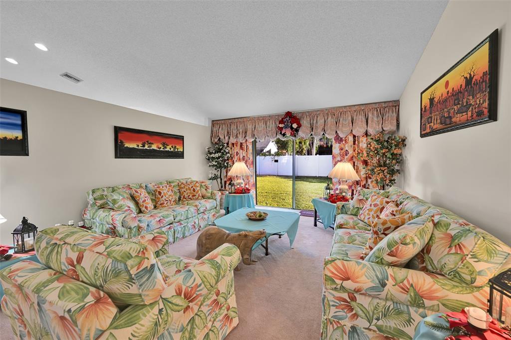 7312 Northwest 83rd Way Tamarac, FL 33321 - Photo 2 of 21 a living room with furniture and a wall painting