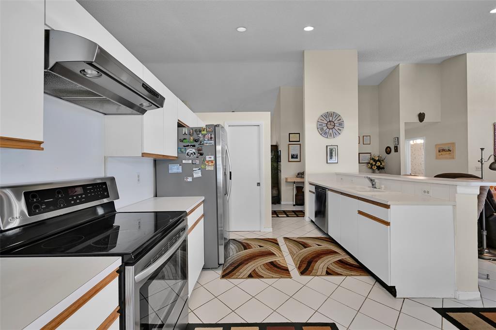 7312 Northwest 83rd Way Tamarac, FL 33321 - Photo 5 of 21 a kitchen with white cabinets and appliances
