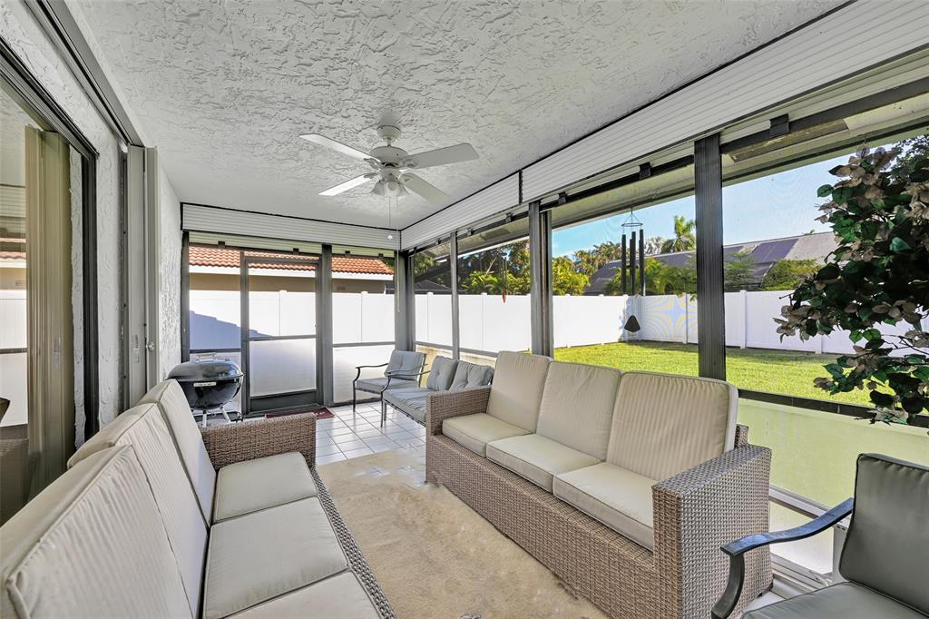 7312 Northwest 83rd Way Tamarac, FL 33321 - Photo 7 of 21 a living room with patio furniture and a floor to ceiling window