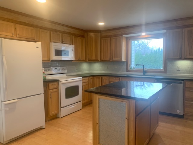 1818 Carr Street Streator, IL 61364 - Photo 12 of 45 a kitchen with granite countertop white cabinets and white appliances