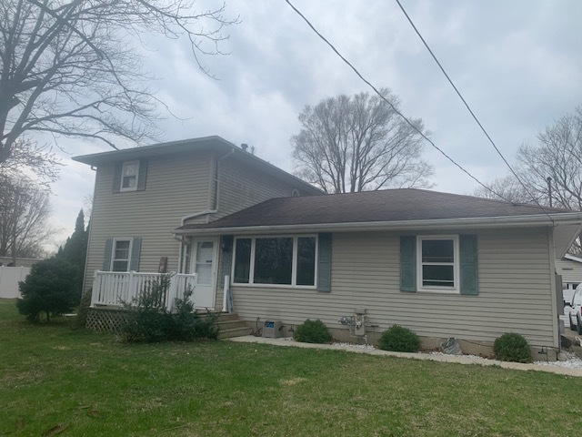 1818 Carr Street Streator, IL 61364 - Photo 2 of 45 a view of a yard in front of a house with plants and large tree
