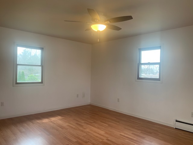 1818 Carr Street Streator, IL 61364 - Photo 25 of 45 an empty room with wooden floor and windows