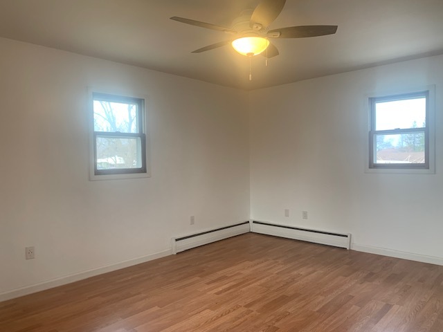 1818 Carr Street Streator, IL 61364 - Photo 28 of 45 an empty room with wooden floor and windows