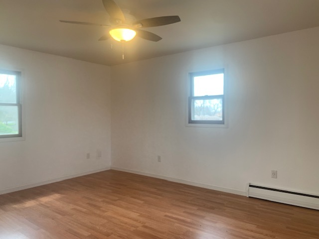 1818 Carr Street Streator, IL 61364 - Photo 29 of 45 an empty room with wooden floor and windows