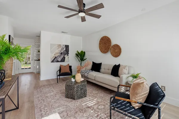 a living room with furniture and a potted plant