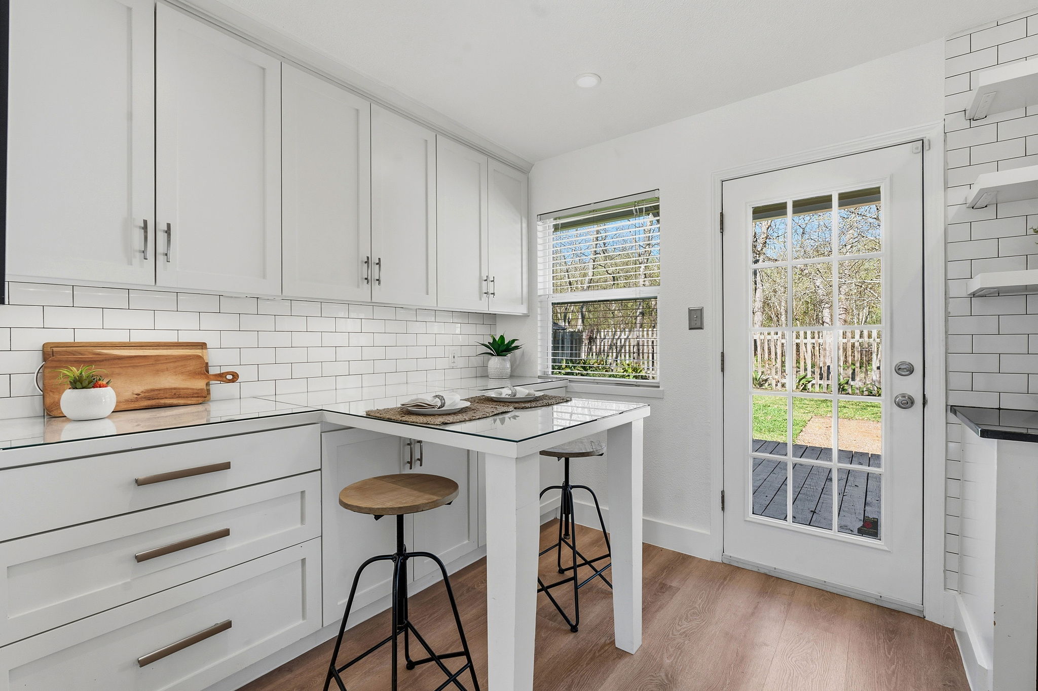 1630 Chippeway Lane Austin, TX 78745 - Photo 13 of 28 The dining area comes lined with gorgeous Shaker-style cabinetry with bonus counter space and a lovely built-in breakfast table for 2-3 stools.