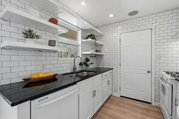 a utility room with stainless steel appliances and cabinets