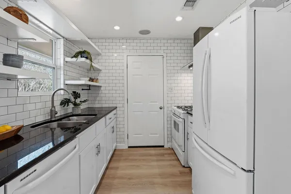 a kitchen with a sink and refrigerator